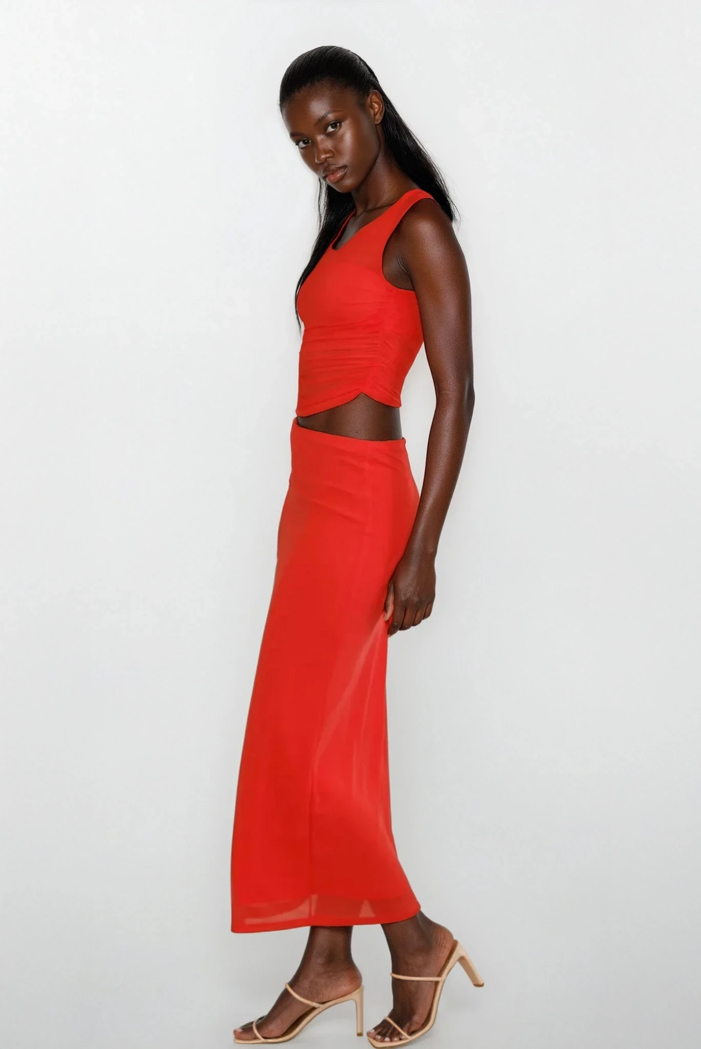 Light blue Echelon asymmetrical cutout sleeveless dress from Trendsi, featuring a stylish design with cutout details and sleeveless style.