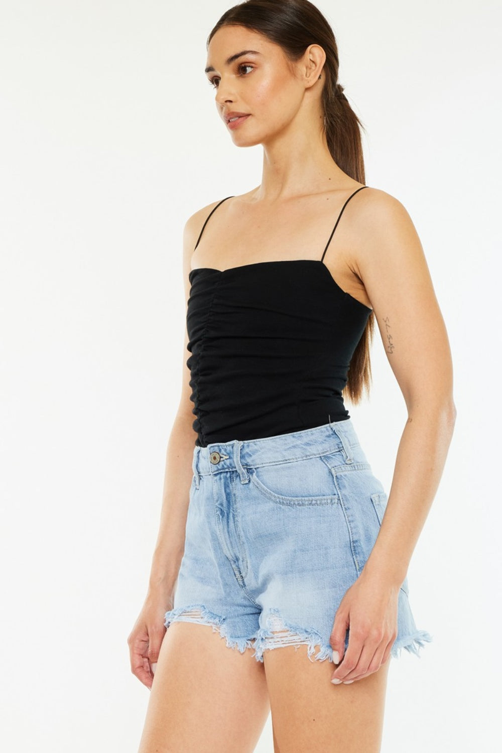Pair of vintage denim shorts with high-waist and raw hem, featuring classic blue wash and distressed details, by Trendsi.