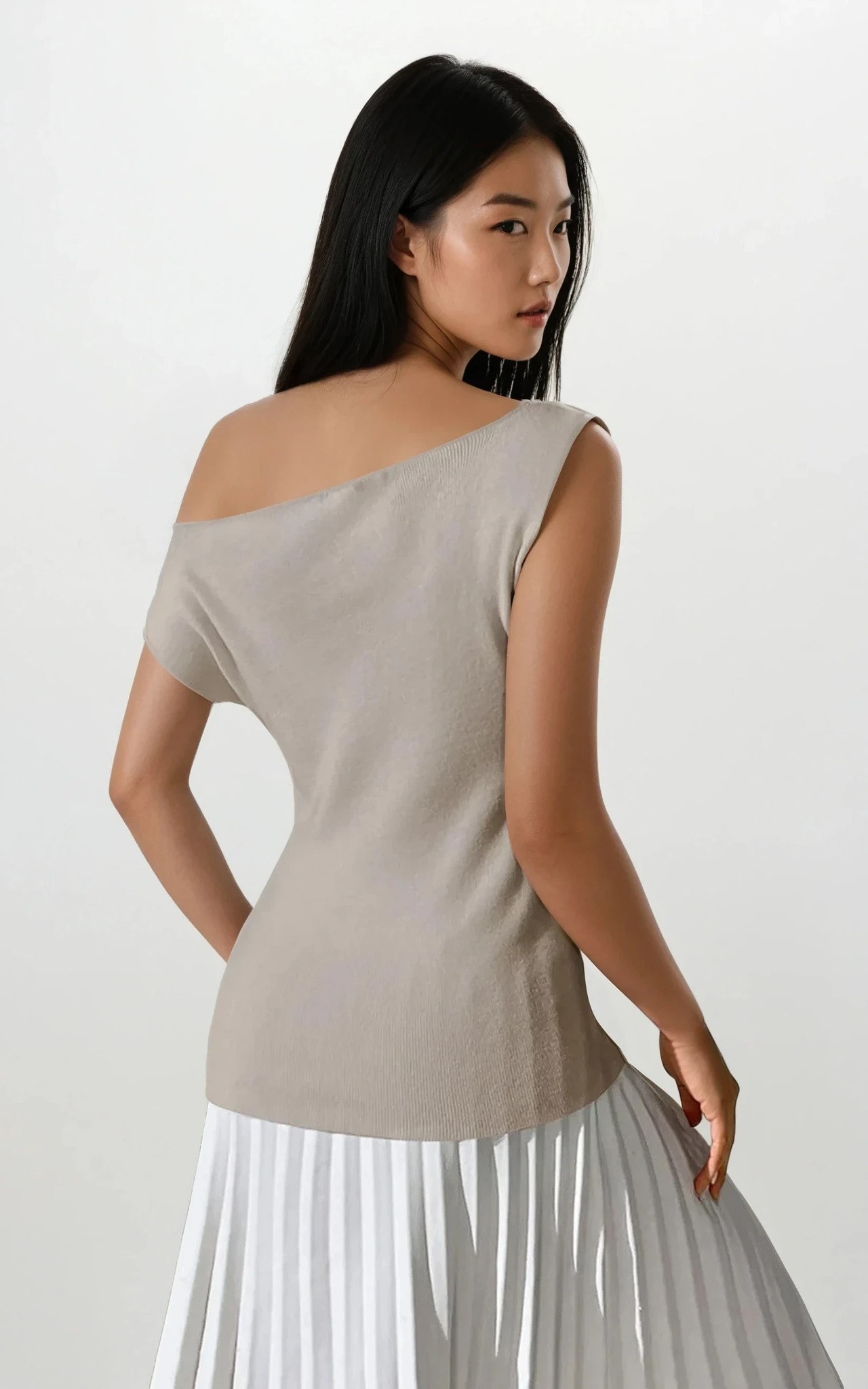 Light gray cold shoulder knit top from Trendsi, featuring long sleeves and a relaxed fit, styled on a model.
