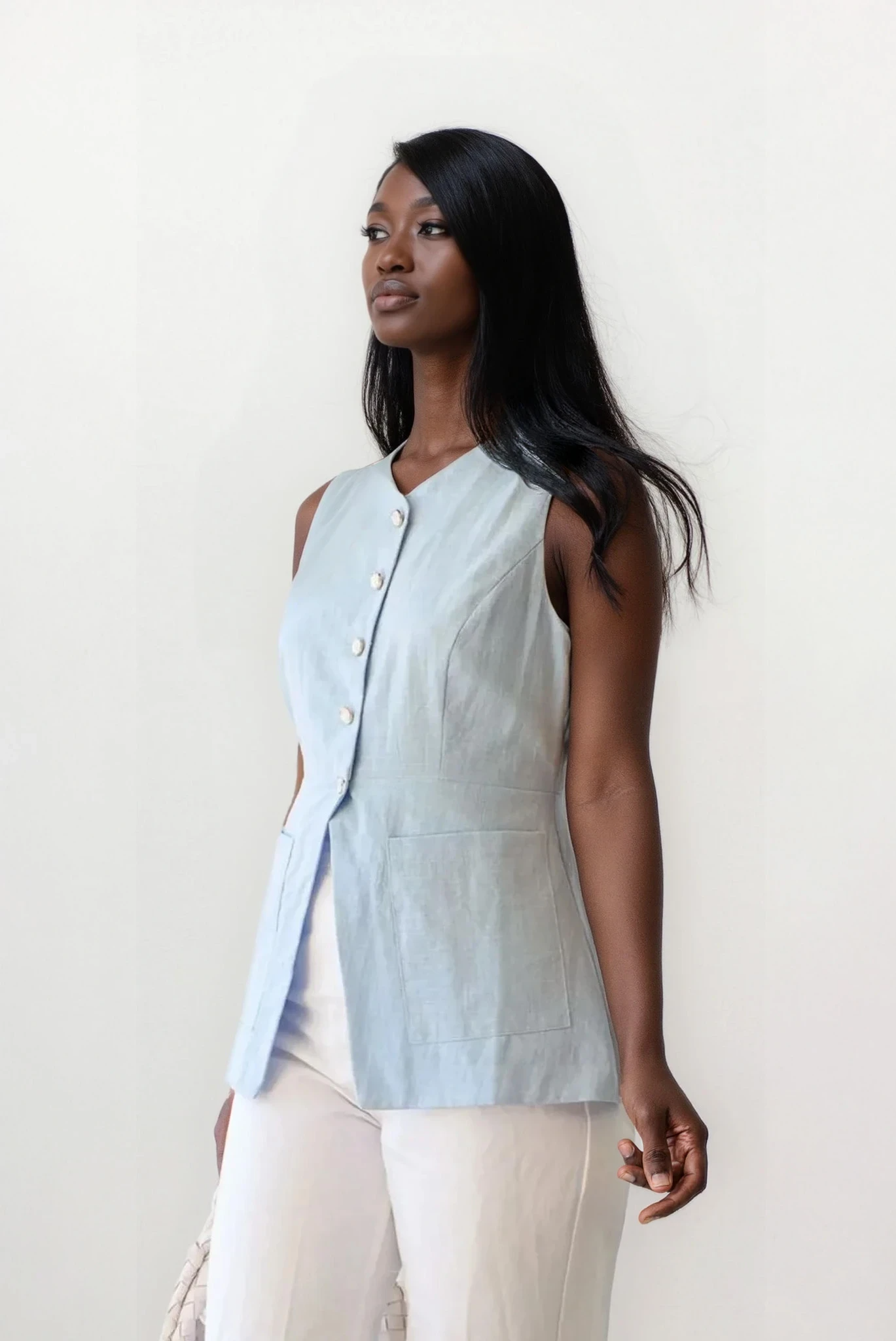 Light blue Trace Button Down V-Neck Vest by Trendsi, casual clothing layered over a top, displayed on a flat surface.