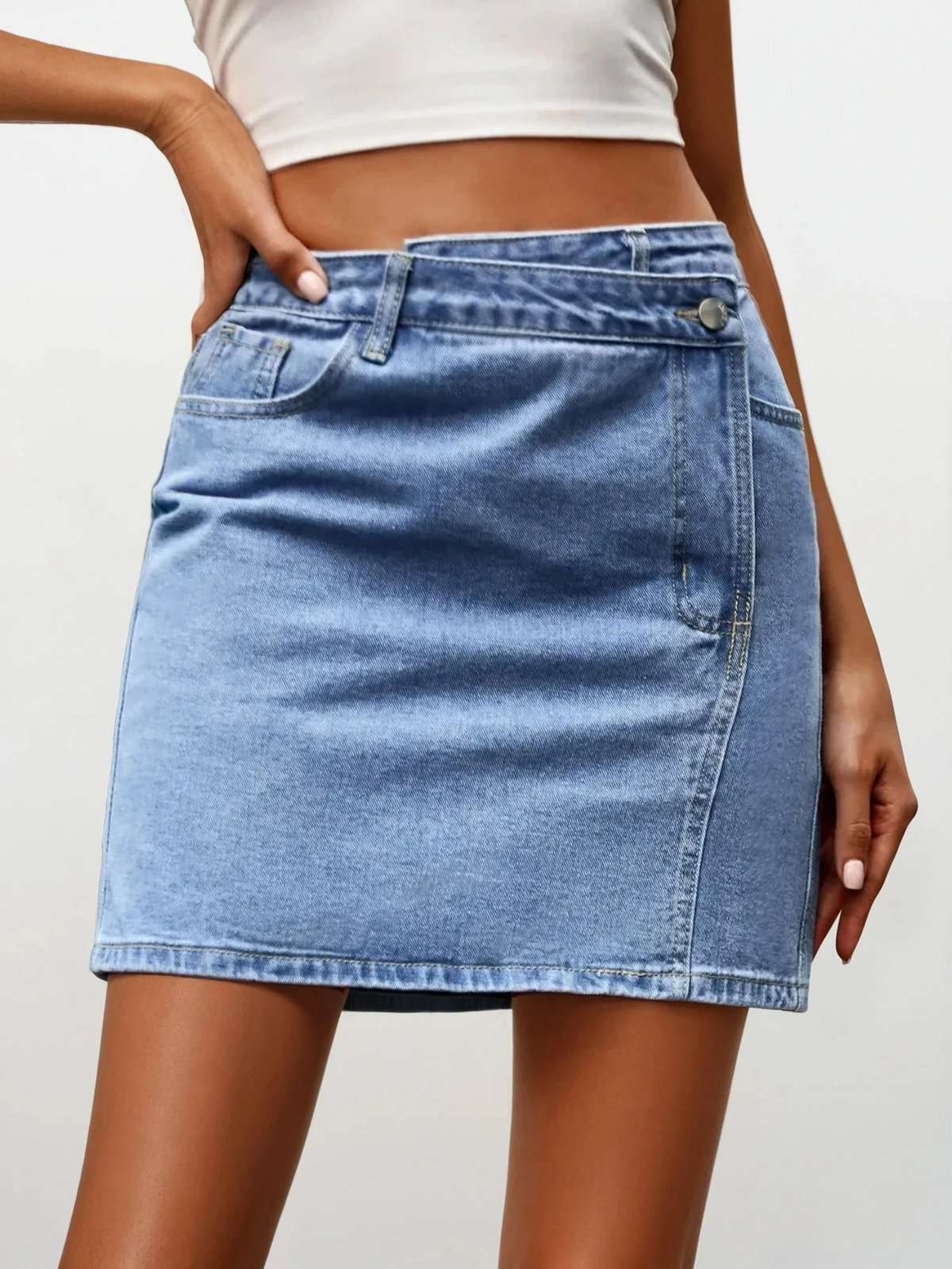 Light blue asymmetrical high-waist denim mini skirt with button closure and pockets