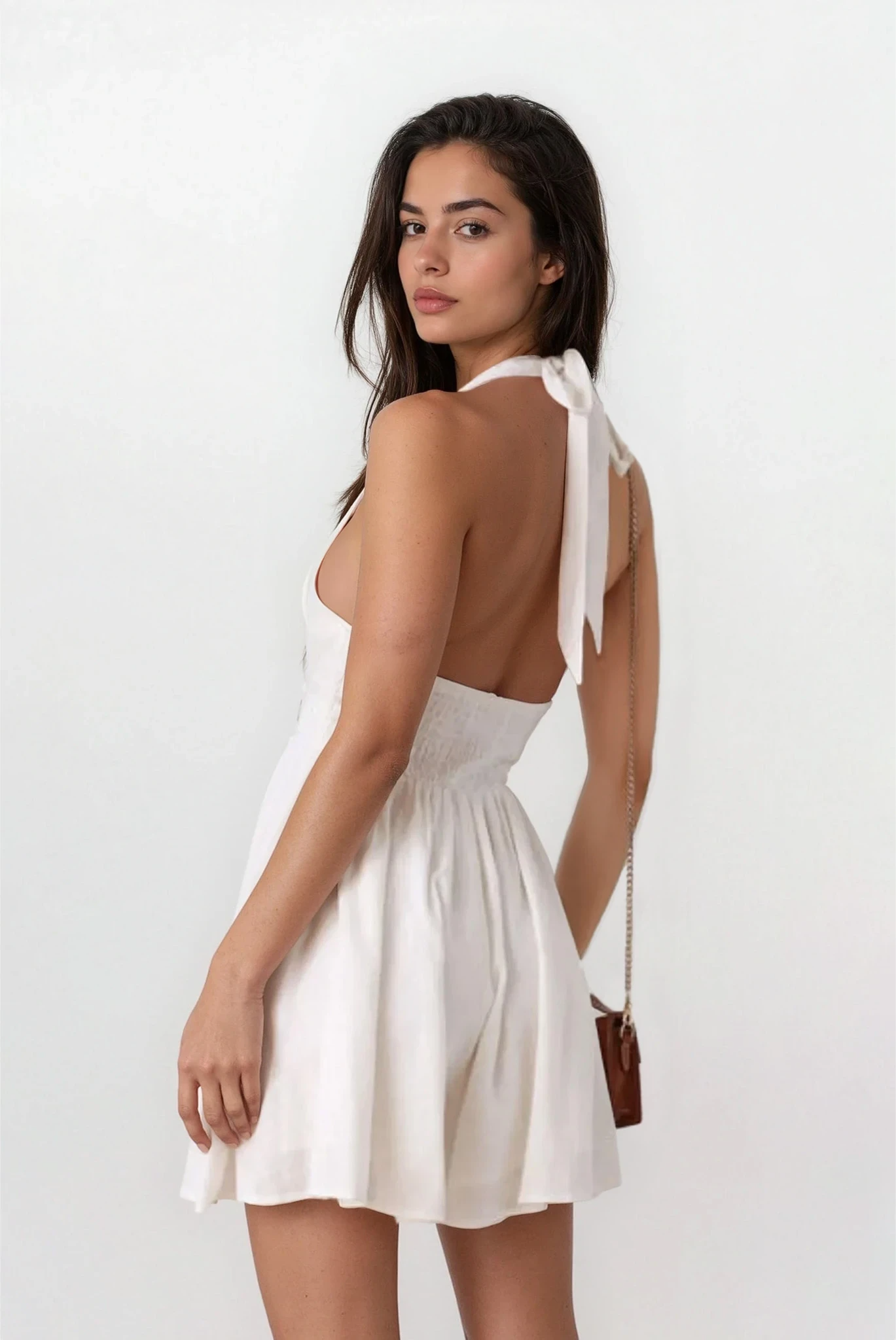 Light-colored Lumina Cutout Halter Neck Mini Dress by Trendsi, showcasing the halter neckline and stylish cutout details.