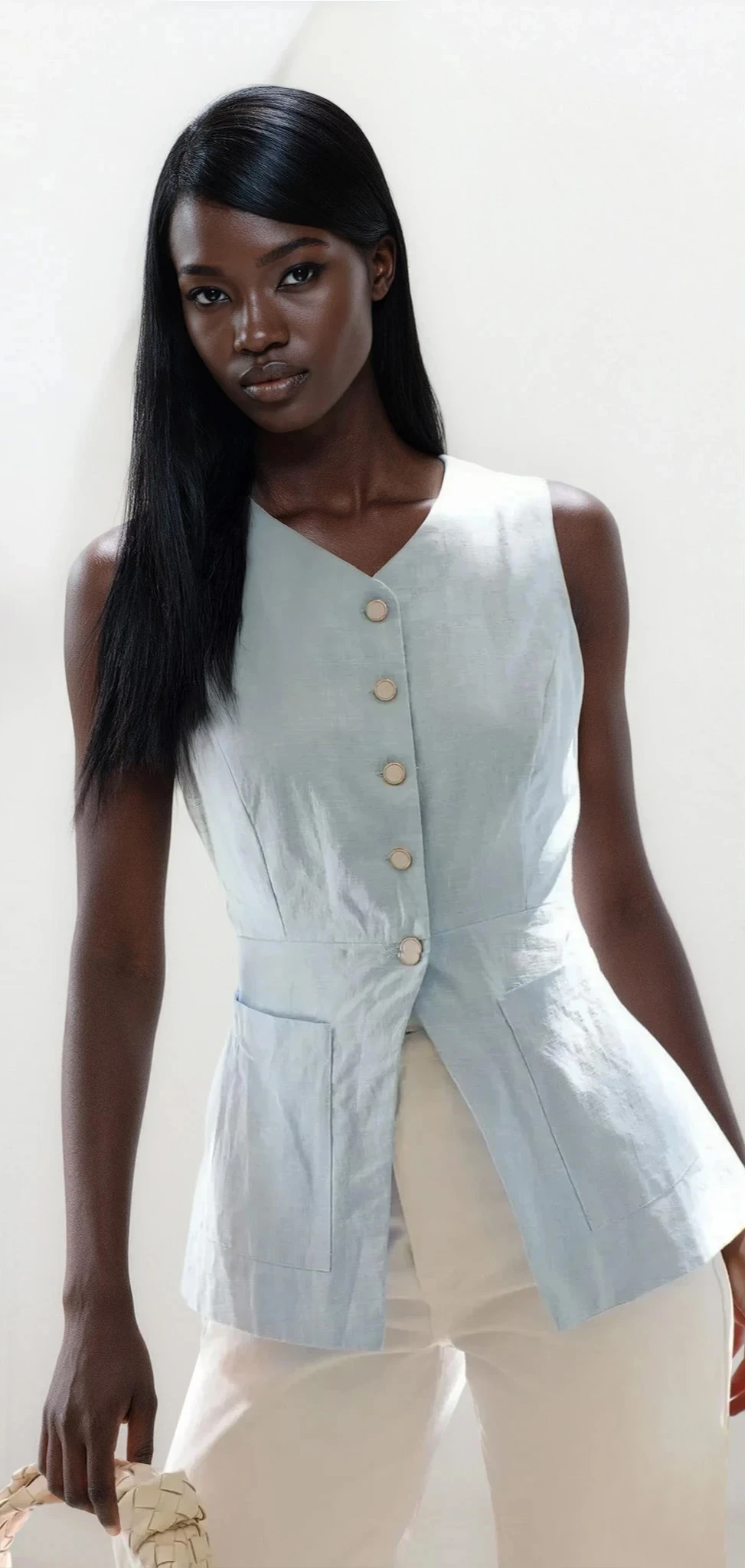 Light blue Trace Button Down V-Neck Vest from Trendsi, showcasing the fabric texture and stylish collar detail.