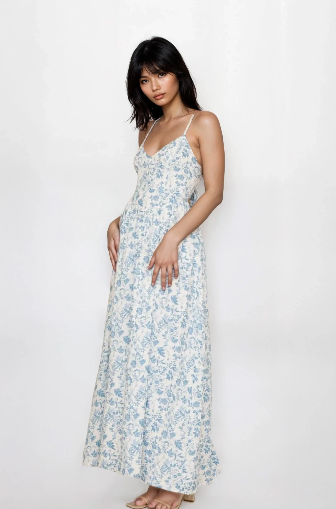 Light-colored Fleuron Bow Back V-Neck Cami Dress from Trendsi featuring a bow detail and V-neckline, displayed on a hanger.