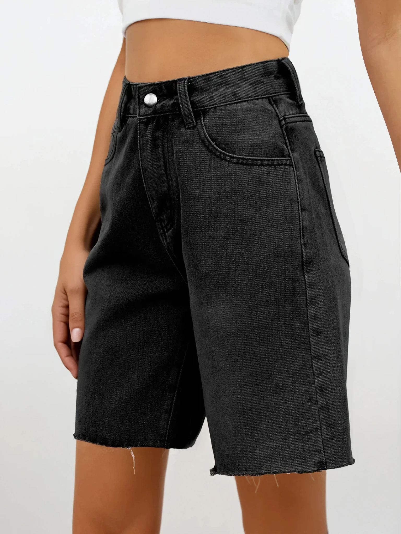 Light studio photo of Rogue Raw Hem Denim Shorts by Trendsi, showcasing their casual fit and distressed raw hem detail.