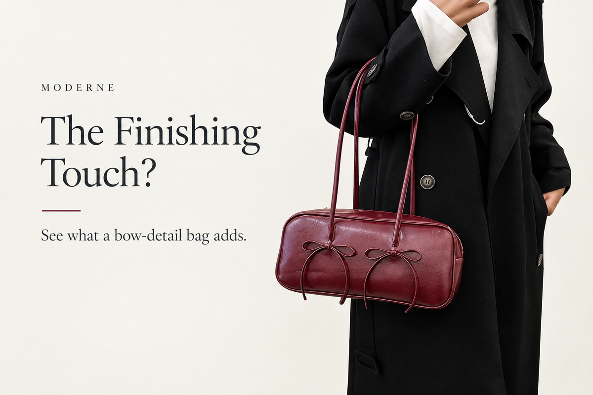Moderne banner reading “The Finishing Touch?” showing a burgundy shoulder bag with two bow details against a black coat and white shirt.