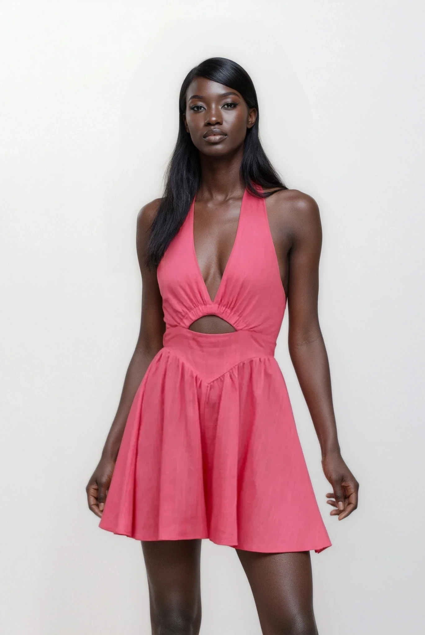 Light-colored Lumina Cutout Halter Neck Mini Dress by Trendsi featuring a stylish halter neckline and cutout details.