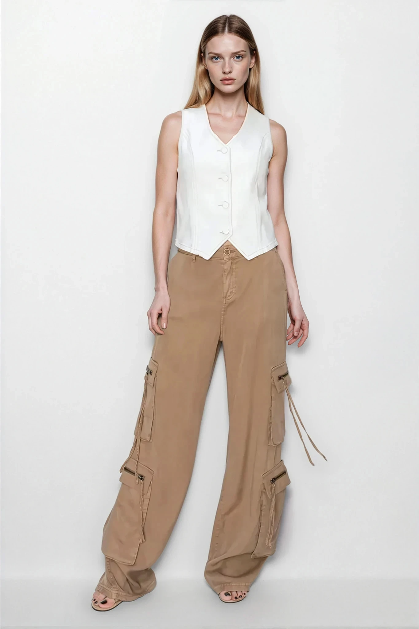 Light beige Marlo V‑Neck Cropped Vest from Trendsi, featuring a fitted V-neck design and cropped length, styled on a model.