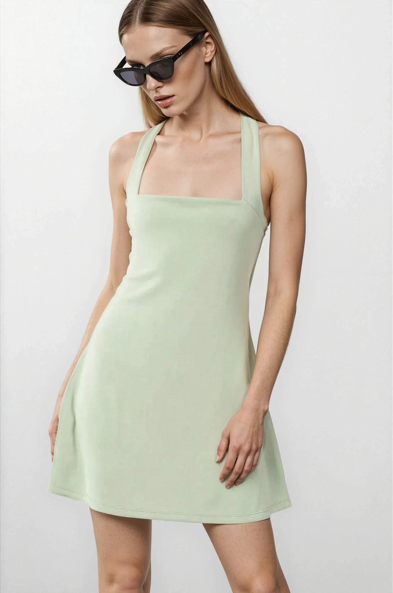 Light blue Eden Crisscross Square Neck Tennis Dress by Trendsi, featuring a fitted silhouette and crisscross neckline.