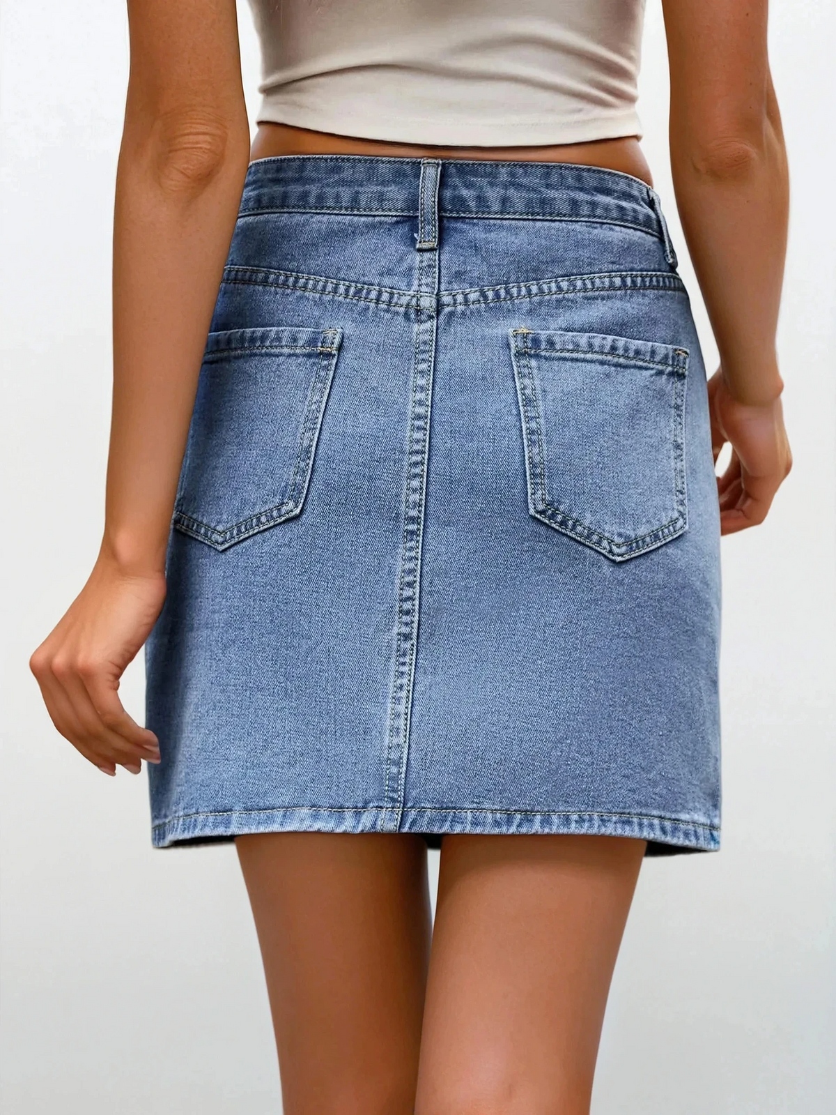 light blue asymmetrical high-waist denim mini skirt with button closure