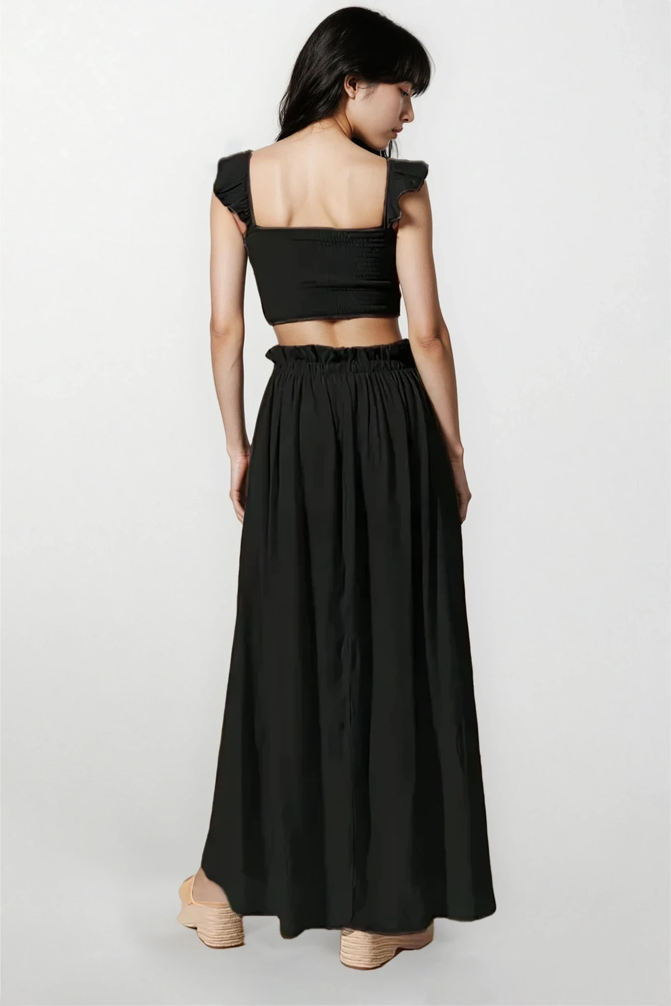 Moonlit smocked top and maxi skirt set from Trendsi, featuring a light fabric and elegant design, perfect for casual or dressy occasions.