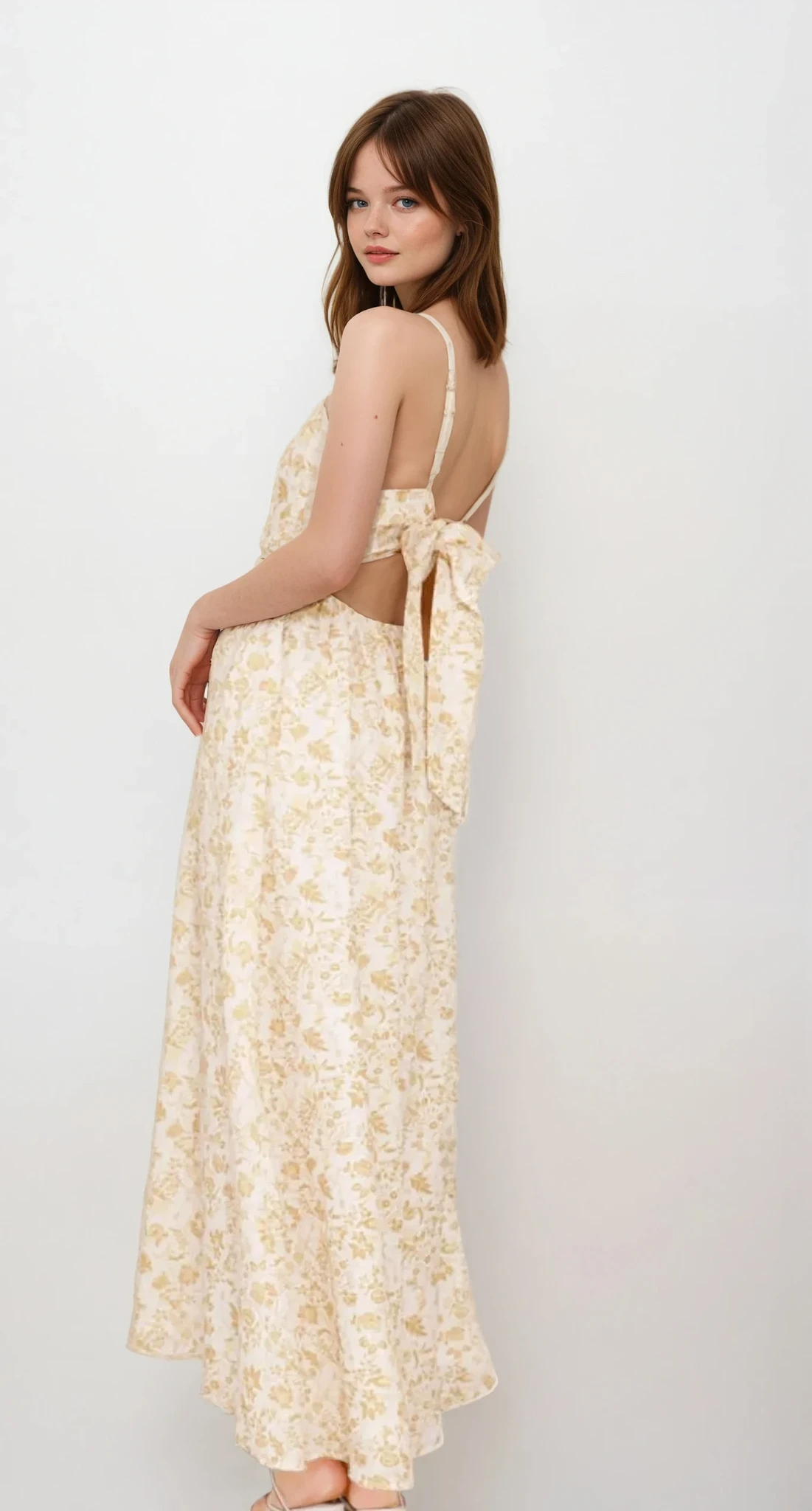 Light-colored Fleuron Bow Back V-Neck Cami Dress by Trendsi, featuring a bow back detail and a V-neck style, perfect for summer wear.