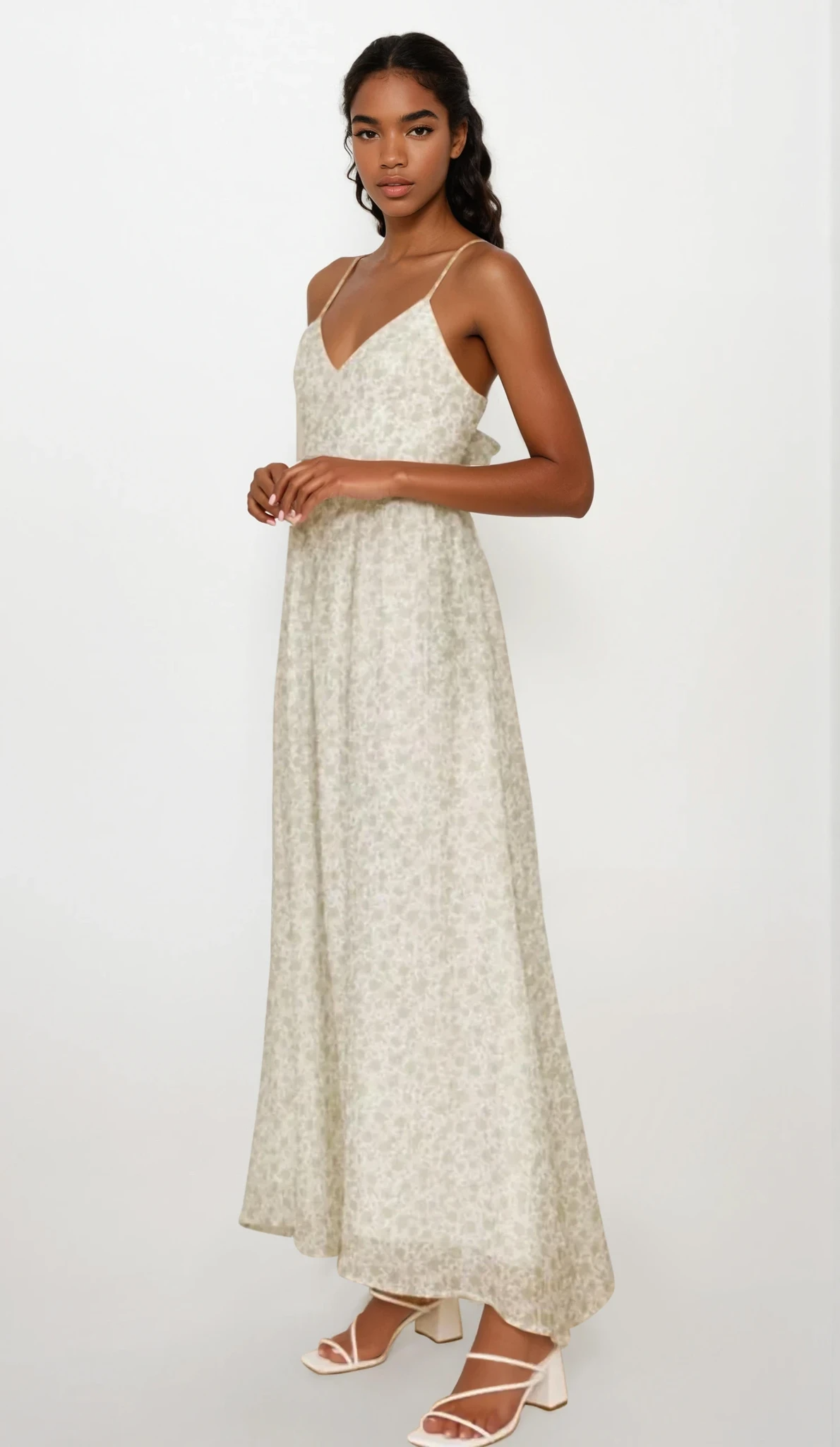 Fleuron Bow Back V-Neck Cami Dress by Trendsi featuring a floral design, bow back detail, and V-neck cut on lightweight fabric