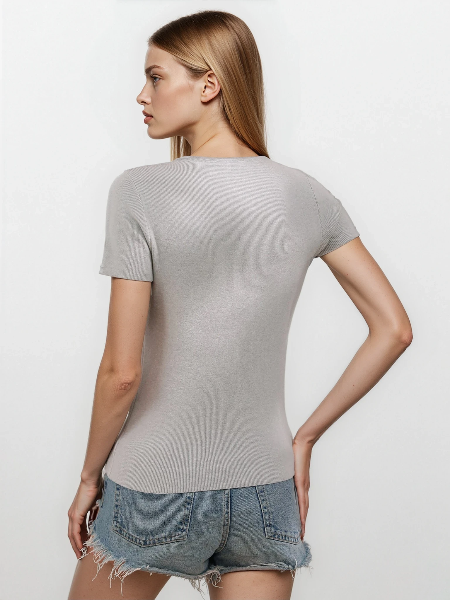 Luxe cutout round neck short sleeve knit top from Trendsi, showcasing a stylish design and soft fabric in a light color.