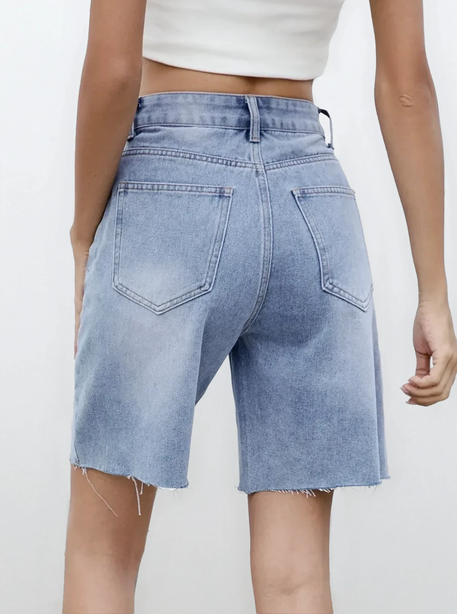Light blue Rogue Raw Hem Denim Shorts by Trendsi, featuring distressed raw edges and a classic denim fit.