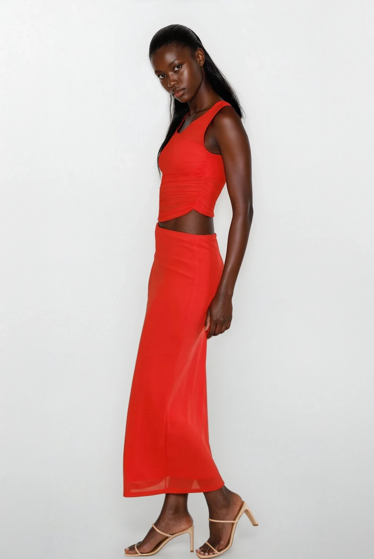 Sleeveless echelon maxi dress with asymmetrical cutout and twisted fabric detail