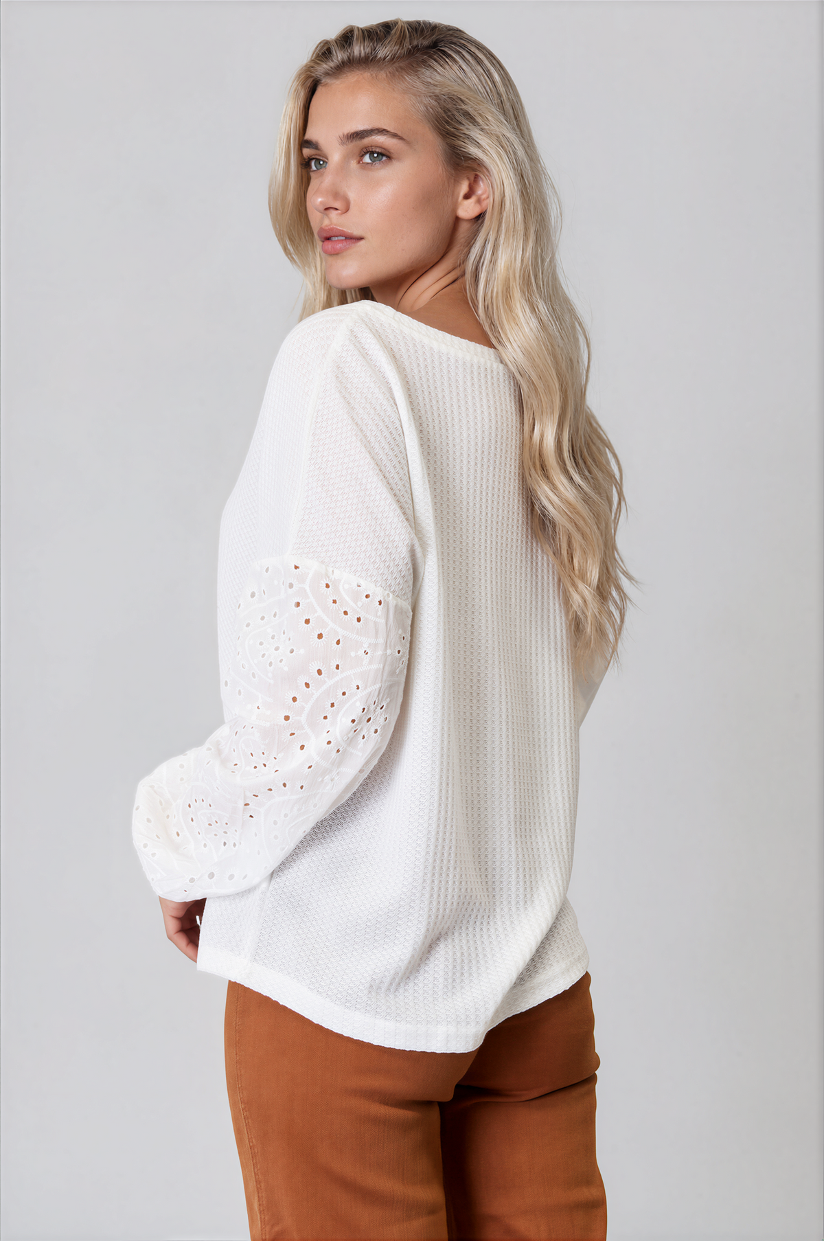 Ethereal Round Neck Eyelet Dropped Shoulder Blouse in white textured knit with eyelet lace sleeves and a relaxed fit