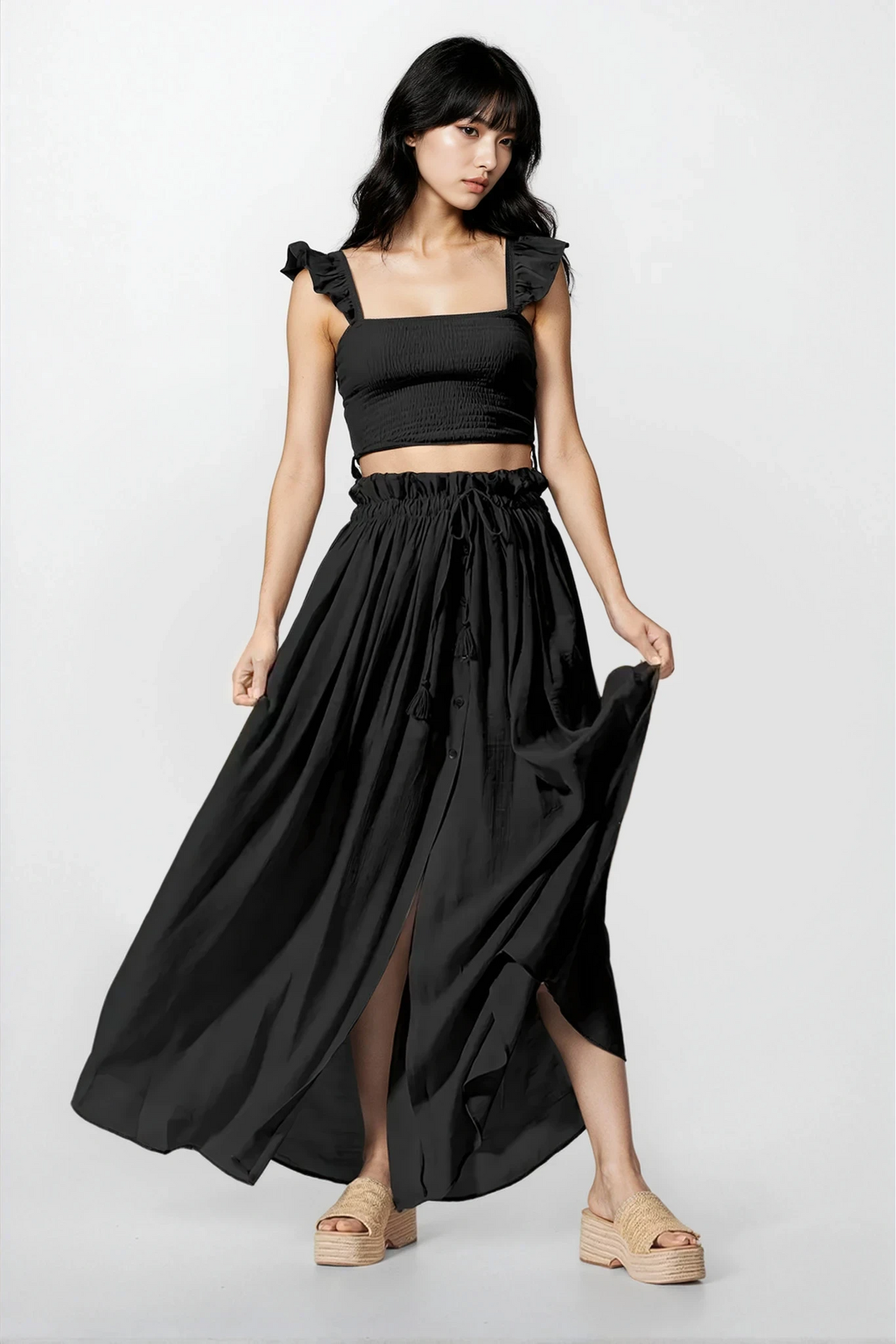 Woman wearing Moonlit Smocked Top and Maxi Skirt Set with leg slit